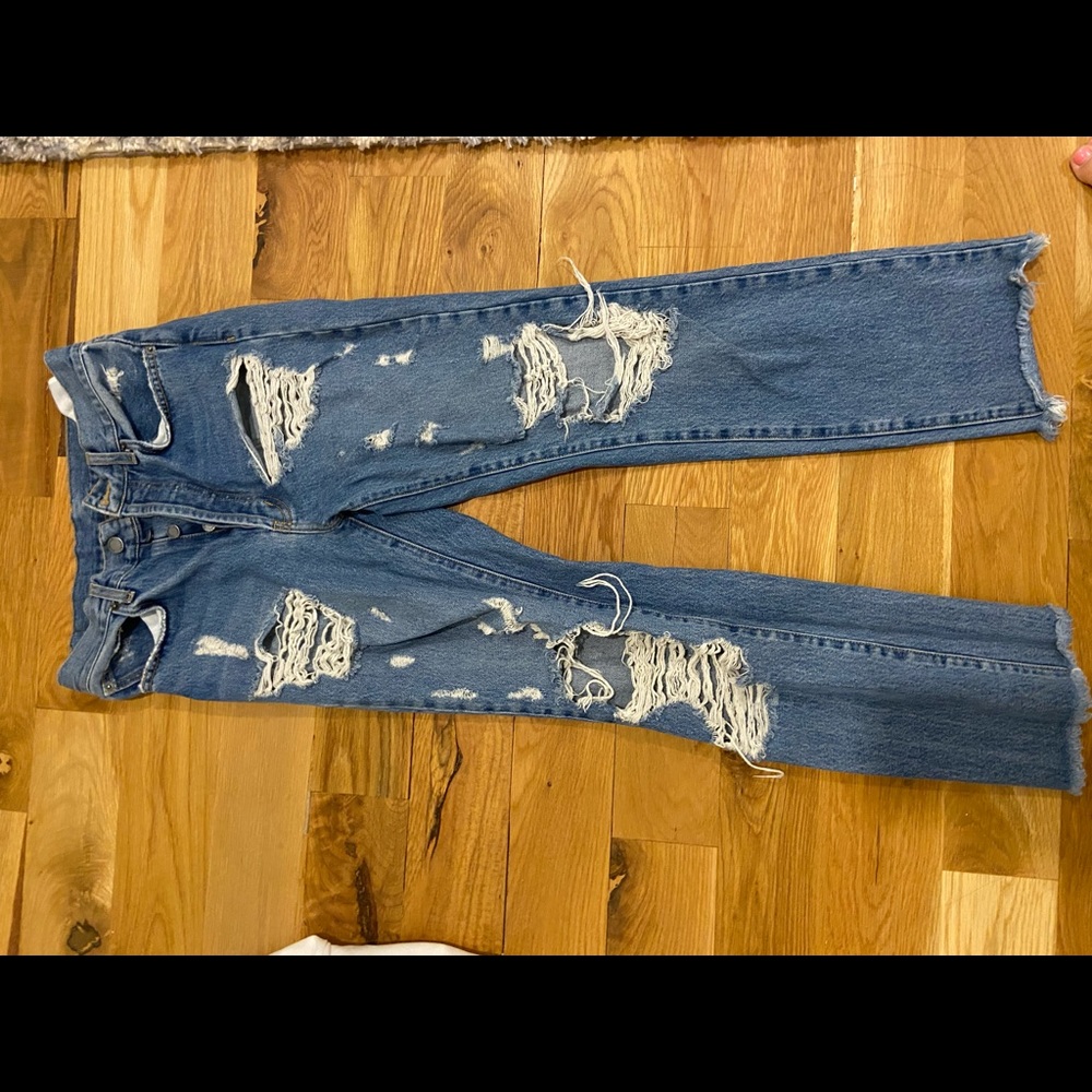 Boyfriend jeans with rips throughout and frayed